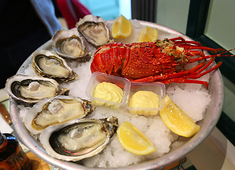 Image showing Large dish with fresh seafood, oysters with lobster with lemon a