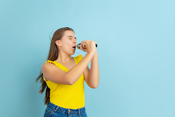 Image showing Caucasian teen girl portrait isolated on blue studio background