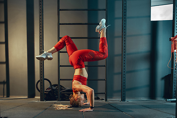 Image showing The female athlete training hard in the gym. Fitness and healthy life concept.