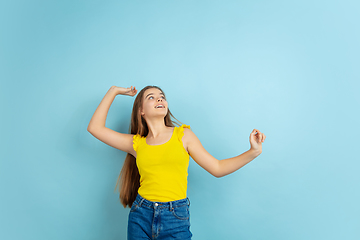 Image showing Caucasian teen girl portrait isolated on blue studio background