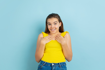 Image showing Caucasian teen girl portrait isolated on blue studio background