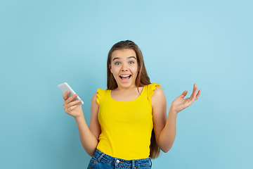 Image showing Caucasian teen girl portrait isolated on blue studio background