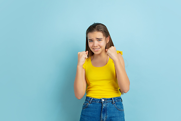 Image showing Caucasian teen girl portrait isolated on blue studio background