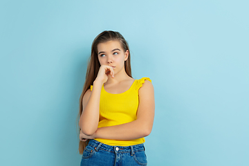 Image showing Caucasian teen girl portrait isolated on blue studio background