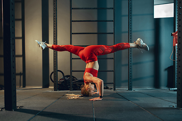 Image showing The female athlete training hard in the gym. Fitness and healthy life concept.