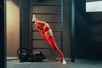 Image showing The female athlete training hard in the gym. Fitness and healthy life concept.