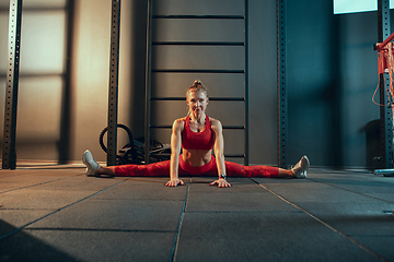 Image showing The female athlete training hard in the gym. Fitness and healthy life concept.