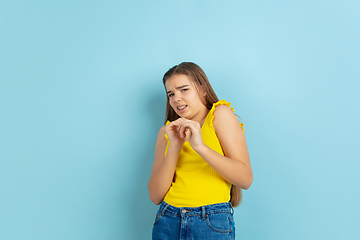 Image showing Caucasian teen girl portrait isolated on blue studio background