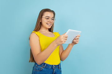 Image showing Caucasian teen girl portrait isolated on blue studio background