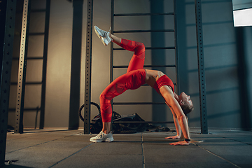 Image showing The female athlete training hard in the gym. Fitness and healthy life concept.