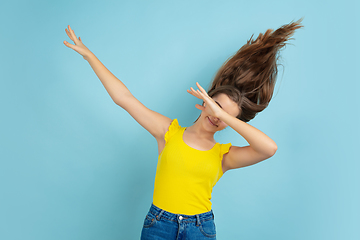 Image showing Caucasian teen girl portrait isolated on blue studio background