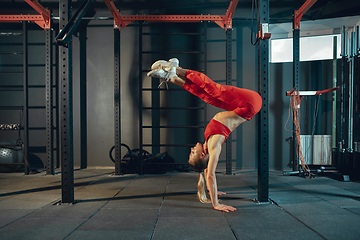 Image showing The female athlete training hard in the gym. Fitness and healthy life concept.