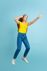 Image showing Caucasian teen girl portrait isolated on blue studio background