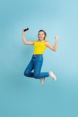 Image showing Caucasian teen girl portrait isolated on blue studio background