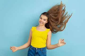 Image showing Caucasian teen girl portrait isolated on blue studio background