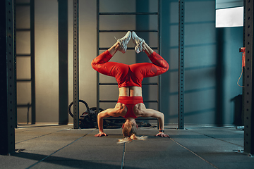 Image showing The female athlete training hard in the gym. Fitness and healthy life concept.