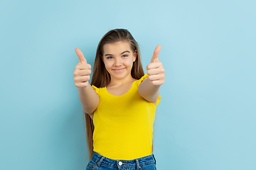 Image showing Caucasian teen girl portrait isolated on blue studio background