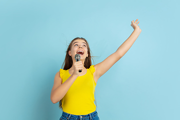 Image showing Caucasian teen girl portrait isolated on blue studio background