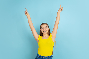 Image showing Caucasian teen girl portrait isolated on blue studio background