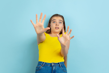 Image showing Caucasian teen girl portrait isolated on blue studio background