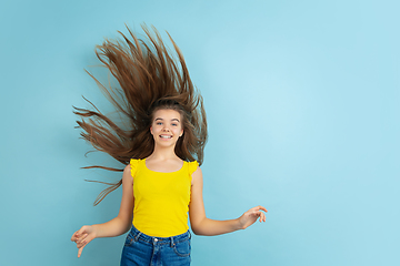 Image showing Caucasian teen girl portrait isolated on blue studio background