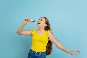 Image showing Caucasian teen girl portrait isolated on blue studio background