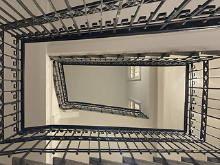 Image showing Old rectangular spiraling winding staircase in an building