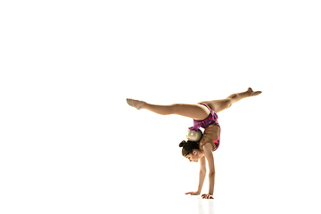 Image showing Young flexible female gymnast isolated on white studio background