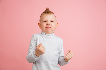 Image showing Happy boy isolated on pink studio background. Looks happy, cheerful, sincere. Copyspace. Childhood, education, emotions concept