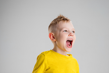 Image showing Happy boy isolated on white studio background. Looks happy, cheerful, sincere. Copyspace. Childhood, education, emotions concept