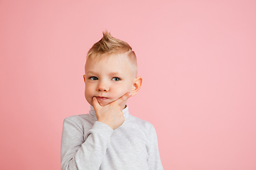 Image showing Happy boy isolated on pink studio background. Looks happy, cheerful, sincere. Copyspace. Childhood, education, emotions concept