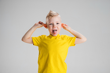 Image showing Happy boy isolated on white studio background. Looks happy, cheerful, sincere. Copyspace. Childhood, education, emotions concept