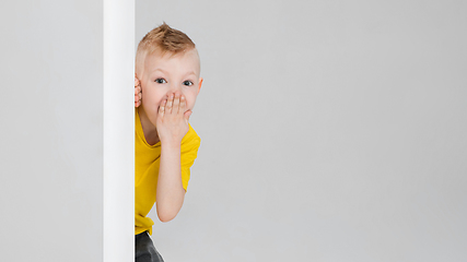 Image showing Happy boy isolated on white studio background. Looks happy, cheerful, sincere. Copyspace. Childhood, education, emotions concept