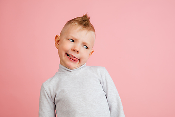 Image showing Happy boy isolated on pink studio background. Looks happy, cheerful, sincere. Copyspace. Childhood, education, emotions concept