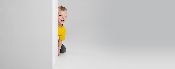 Image showing Happy boy isolated on white studio background. Looks happy, cheerful, sincere. Copyspace. Childhood, education, emotions concept