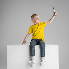 Image showing Happy boy isolated on white studio background. Looks happy, cheerful, sincere. Copyspace. Childhood, education, emotions concept