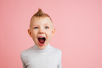 Image showing Happy boy isolated on pink studio background. Looks happy, cheerful, sincere. Copyspace. Childhood, education, emotions concept