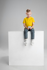 Image showing Happy boy isolated on white studio background. Looks happy, cheerful, sincere. Copyspace. Childhood, education, emotions concept