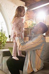 Image showing Smiling. Happy father and little cute daughter at home. Family time, togehterness, parenting and happy childhood concept. Weekend with sincere emotions.