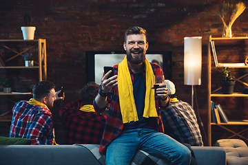 Image showing Group of friends watching TV, sport match together. Emotional man cheering for favourite team, celebrating successful betting. Concept of friendship, leisure activity, emotions