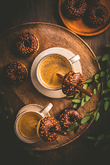 Image showing Two cups of Caffe Americano with small chocolate donuts