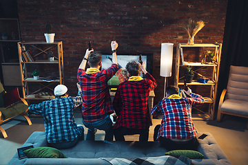 Image showing Group of friends watching TV, sport match together. Emotional fans cheering for favourite team, watching on exciting game. Concept of friendship, leisure activity, emotions