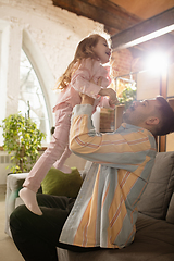 Image showing Smiling. Happy father and little cute daughter at home. Family time, togehterness, parenting and happy childhood concept. Weekend with sincere emotions.