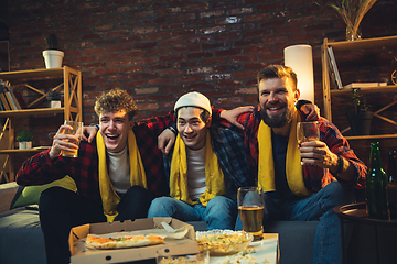 Image showing Group of friends watching TV, sport match together. Emotional fans cheering for favourite team, watching on exciting game. Concept of friendship, leisure activity, emotions