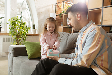 Image showing Happy father and little cute daughter at home. Family time, togehterness, parenting and happy childhood concept. Weekend with sincere emotions.