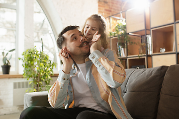 Image showing Happy father and little cute daughter at home. Family time, togehterness, parenting and happy childhood concept. Weekend with sincere emotions.