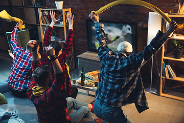 Image showing Group of friends watching TV, sport match together. Emotional fans cheering for favourite team, watching on exciting game. Concept of friendship, leisure activity, emotions