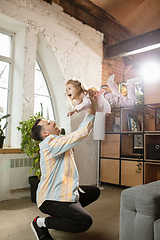 Image showing Happy father and little cute daughter at home. Family time, togehterness, parenting and happy childhood concept. Weekend with sincere emotions.