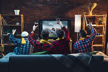 Image showing Group of friends watching TV, sport match together. Emotional fans cheering for favourite team. Top view. Concept of friendship, leisure activity, emotions