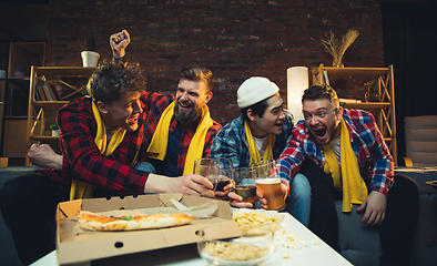 Image showing Group of friends watching TV, sport match together. Emotional fans cheering for favourite team, watching on exciting game. Concept of friendship, leisure activity, emotions